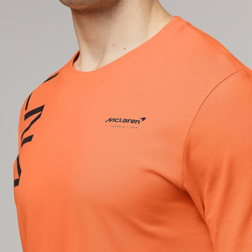 Orange McLaren Formula 1 Team Lando Norris core t-shirt worn by a man.