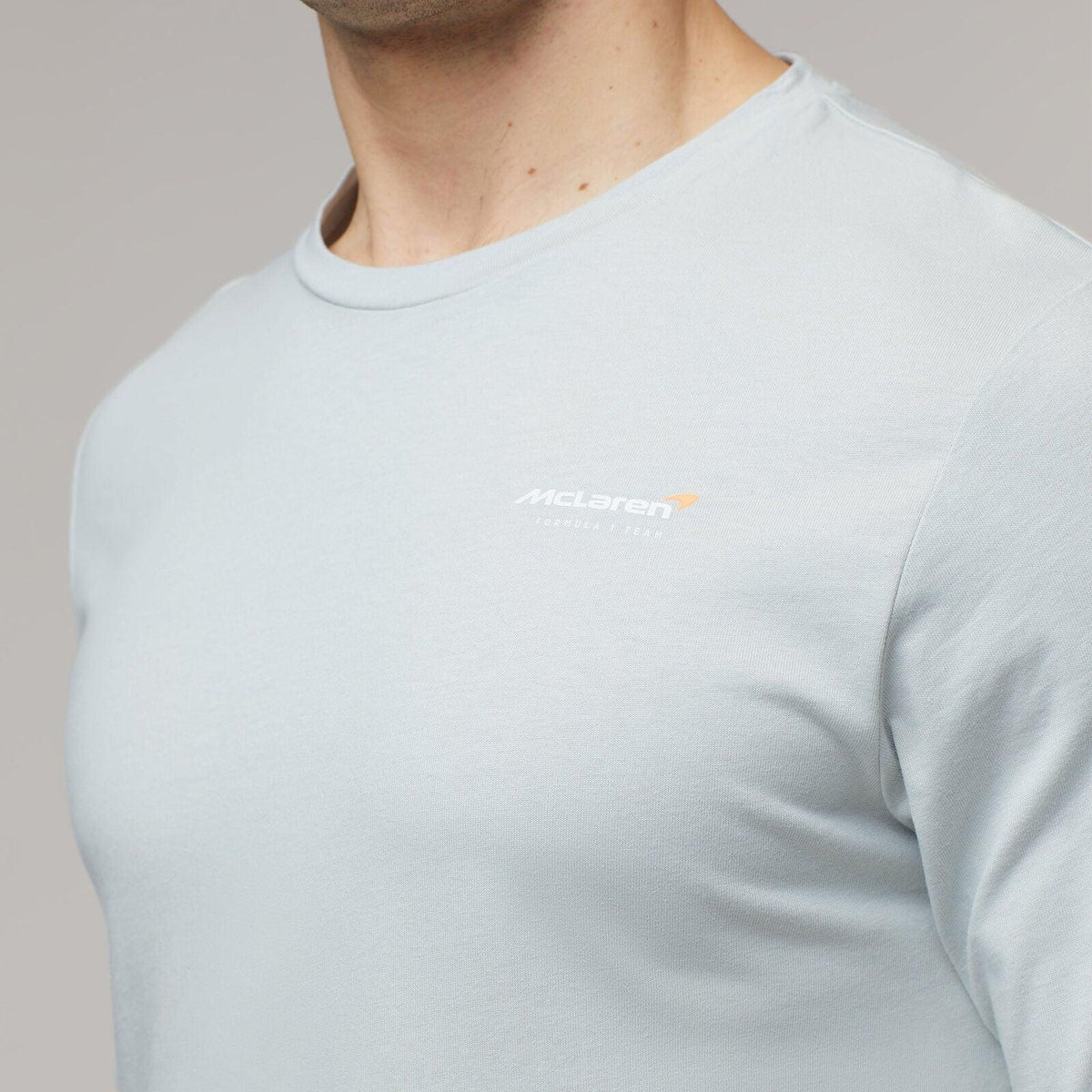 Man wearing a light blue McLaren F1 Lando Norris Core Essentials T-shirt.