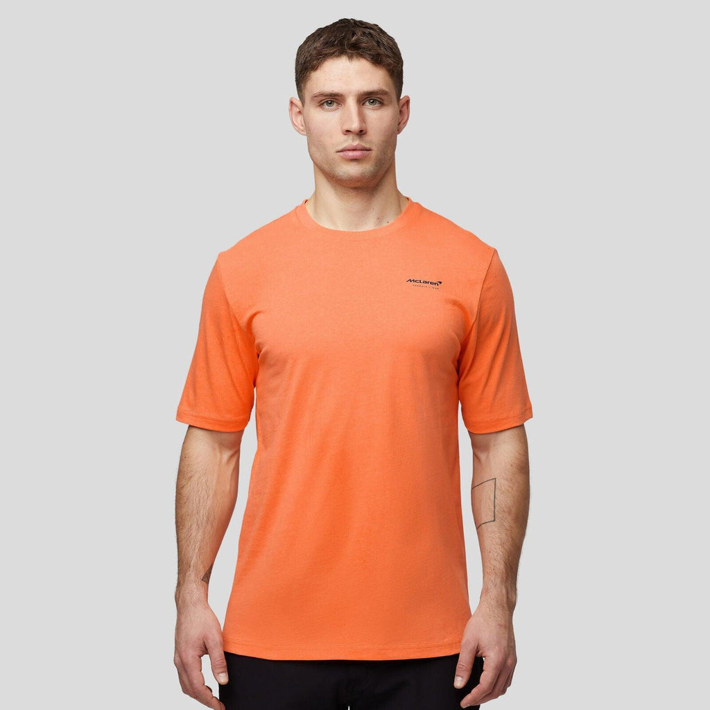 Man wearing a McLaren F1 Lando Norris Core Essentials orange T-shirt