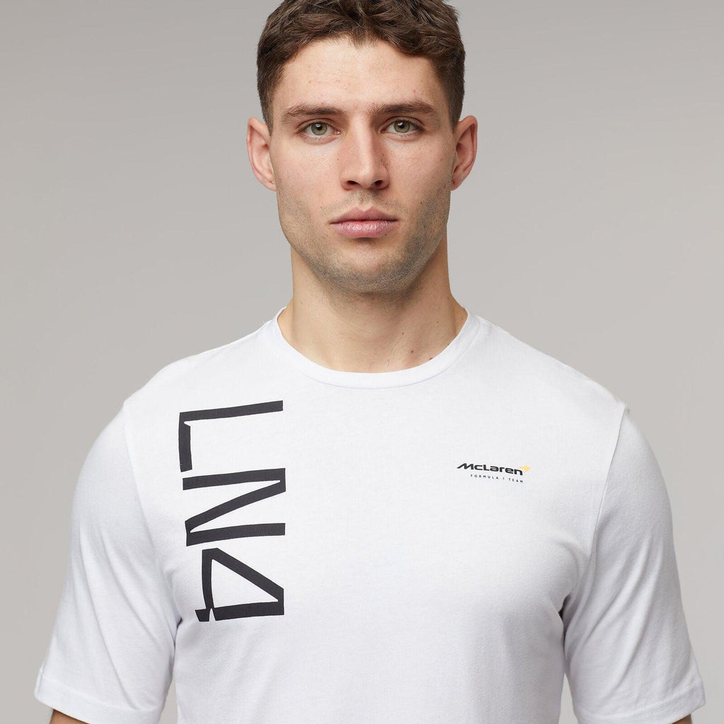 Man wearing a white McLaren F1 Lando Norris Core T-shirt with LN4 graphic.