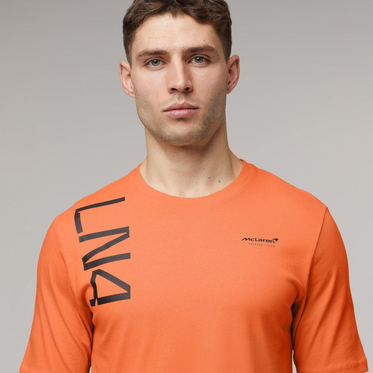 Man wearing an orange McLaren F1 Lando Norris Core T-shirt