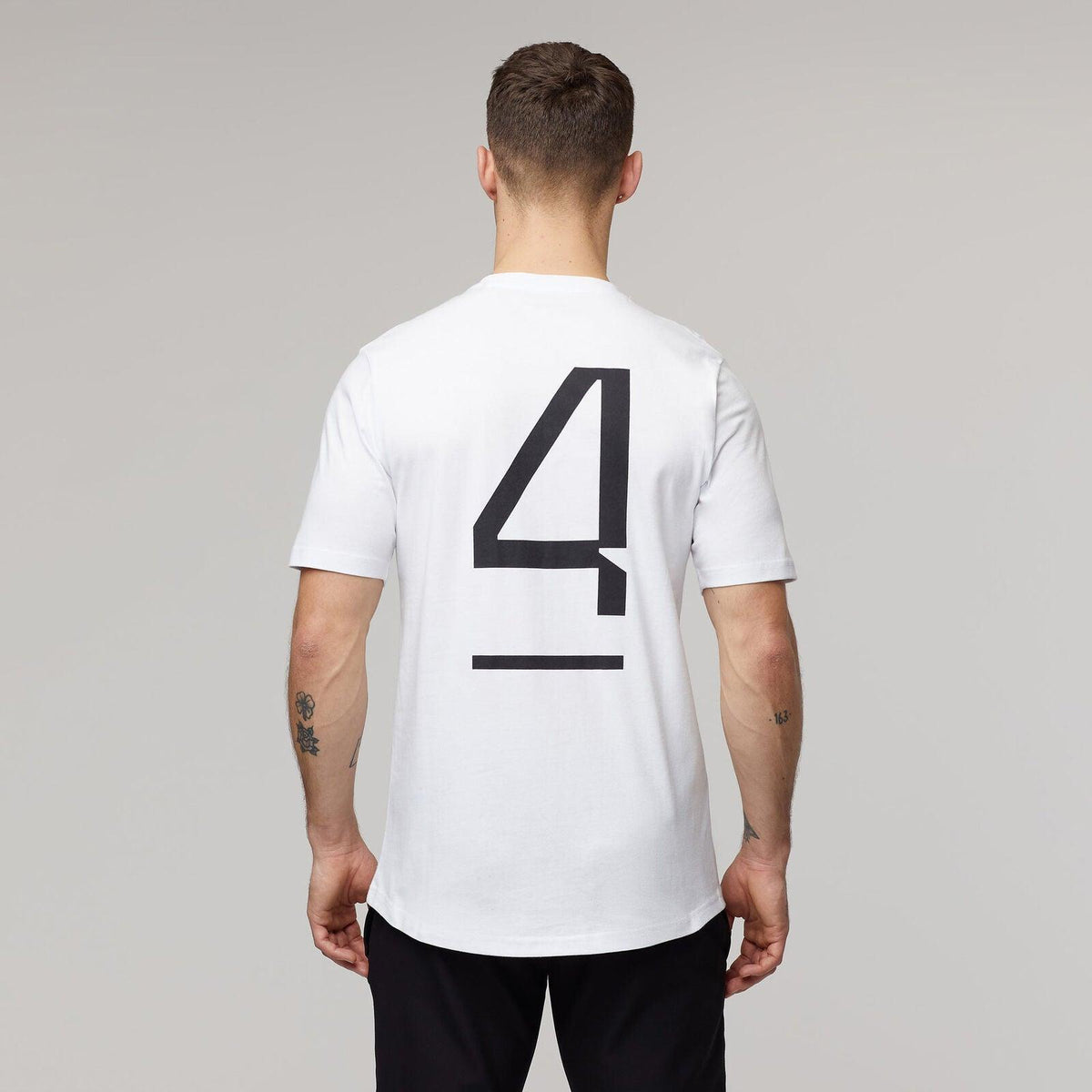 Back view of a white McLaren F1 Lando Norris Core T-shirt featuring a large black number 4.