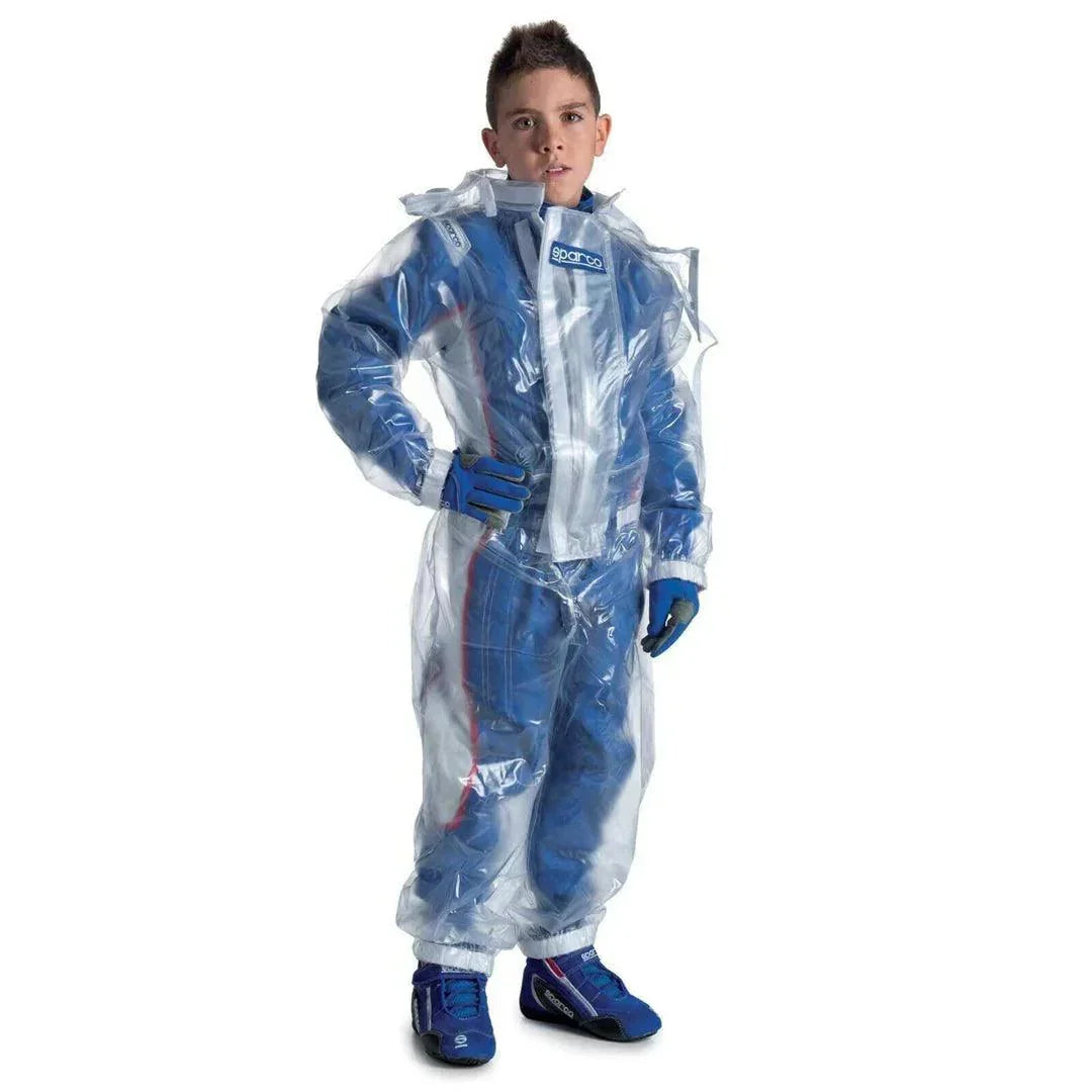 A child wearing a transparent Rustle Racewears kart rain suit over a blue racing outfit.