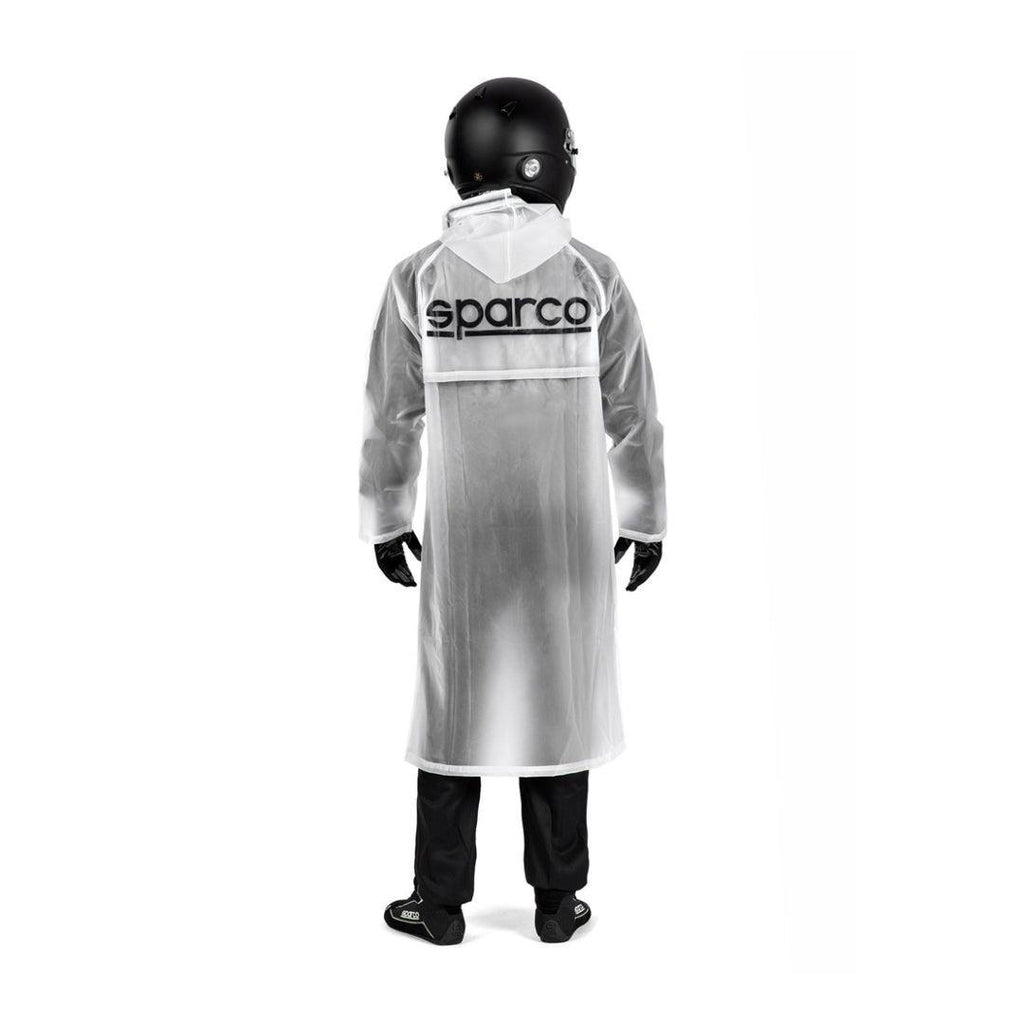 Sparco Raincoat Evo waterproof karting jacket worn by a racer in a black helmet.
